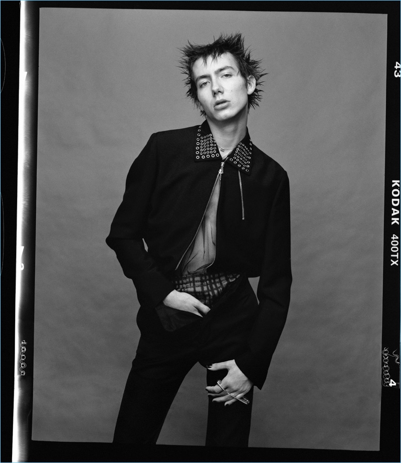 Embracing a punk cool, Paul Hameline wears a jacket and pants by Valentino.