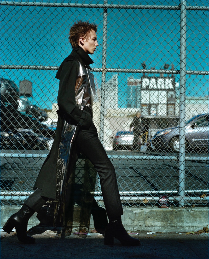 Heading outdoors, Paul Hameline wears a Comme des Garçons Homme Plus coat with pants and boots by Balenciaga.