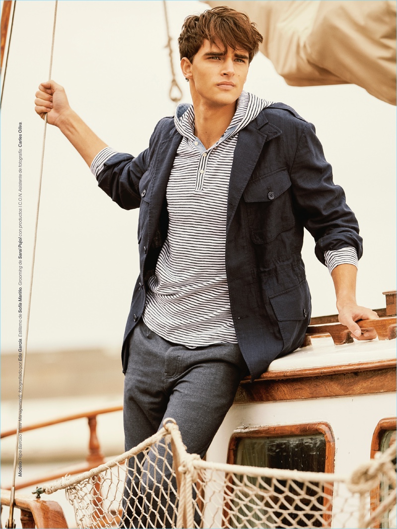 Setting sail, Pepe Barroso Silva models a POLO Ralph Lauren jacket with a Bench hoodie and Springfield pants.