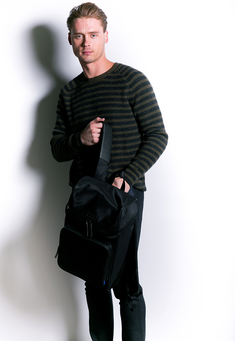 Andrew wears striped sweater Vince, pants Closed, and backpack Uri Minkoff.