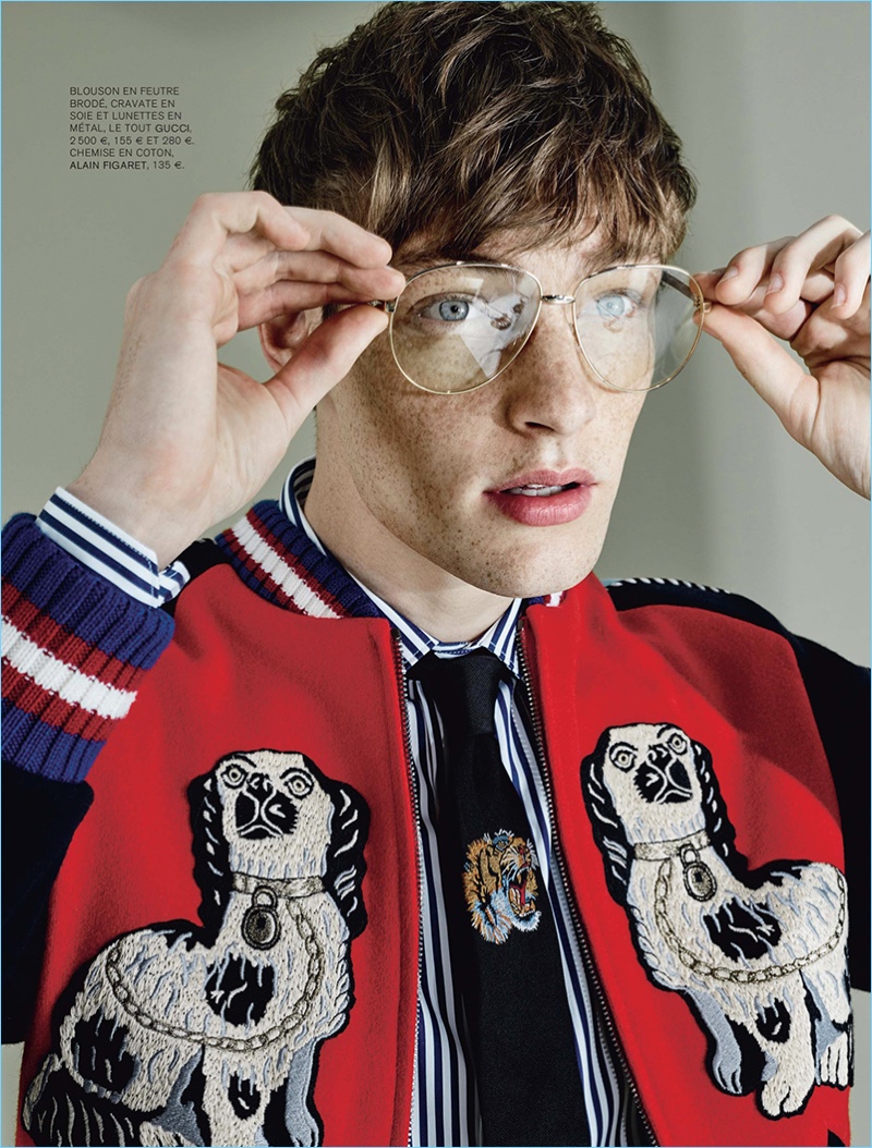 Wearing Gucci, Roberto Sipos adjusts his oversized glasses.