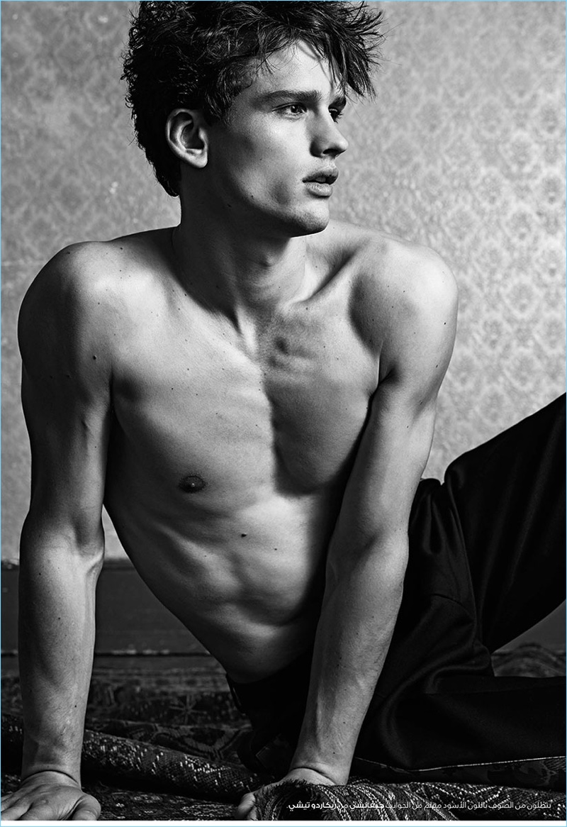 Sitting for a shirtless photo, Simon Nessman wears Givenchy trousers.