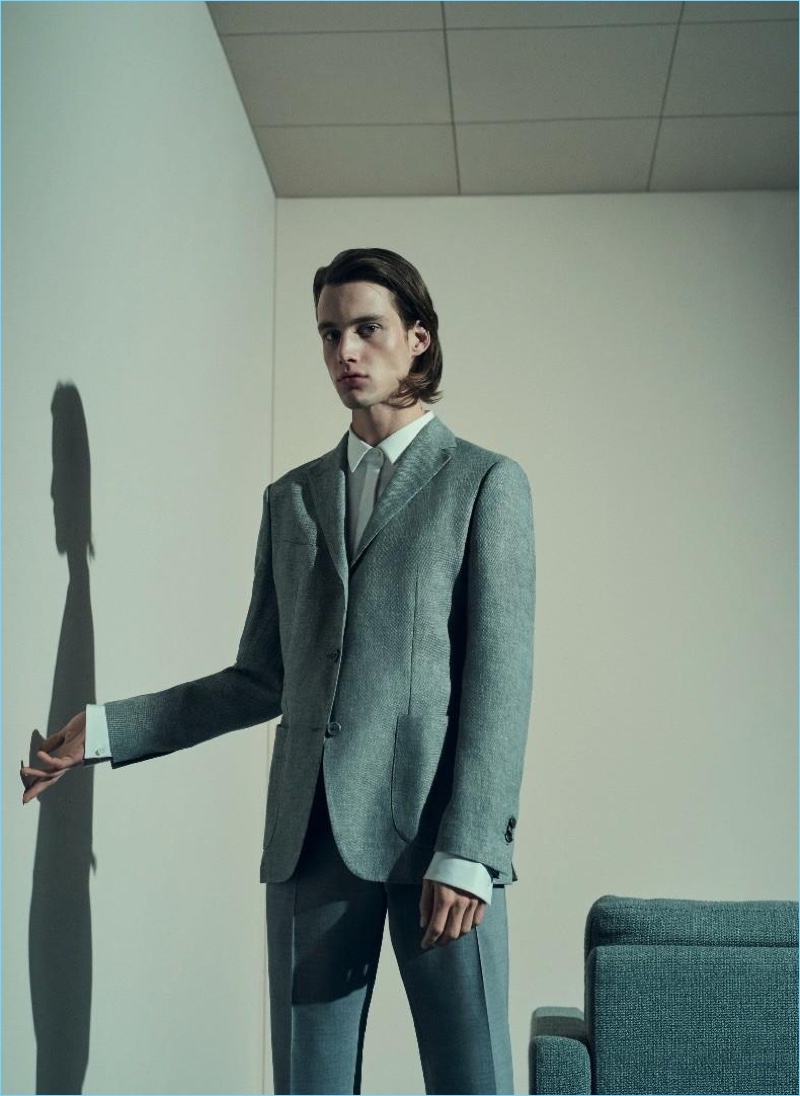 Embracing professional style, Sylvester Ulv wears a shirt, jacket, and trousers by Windsor.
