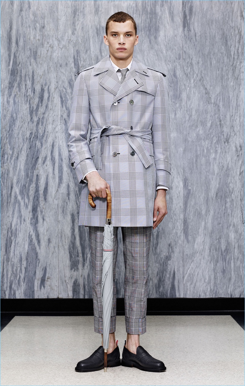 Louis Mayhew dons a trench coat and cropped trousers from Thom Browne's spring-summer 2017 collection.