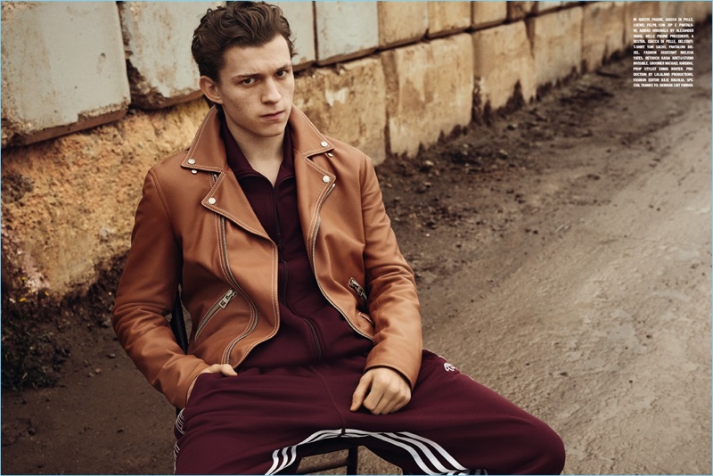 Appearing in a photo shoot for L'Uomo Vogue, Tom Holland wears a brown Loewe leather jacket  with a jumpsuit from Adidas Originals by Alexander Wang. 