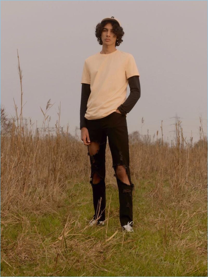 Model Callum Stoddart layers a long-sleeve tee with a short-sleeve t-shirt and extreme ripped skinny jeans from Topman.