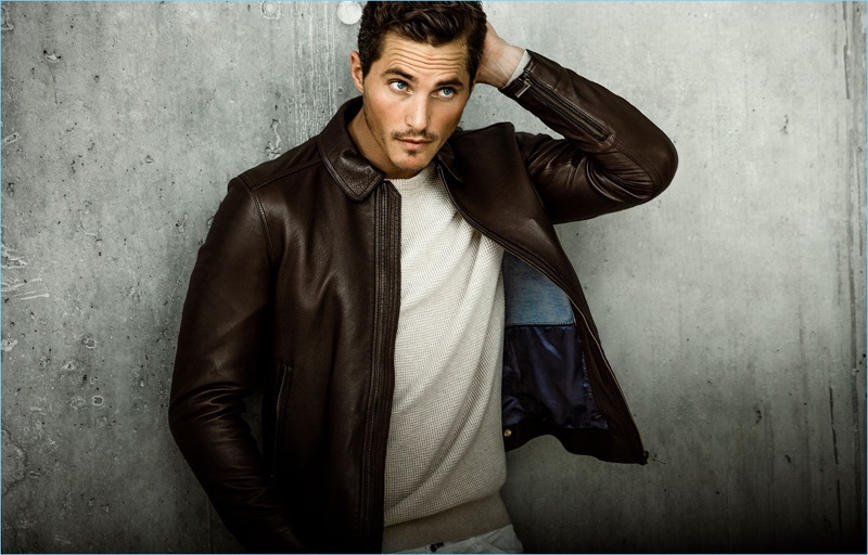 Model Ollie Edwards sports a leather jacket with a sweater by Massimo Dutti.