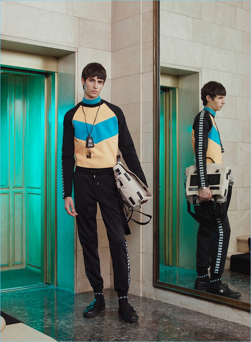 Model Oscar Kindelan sports a color blocked sweatshirt from Versus Versace's pre-fall 2017 collection.