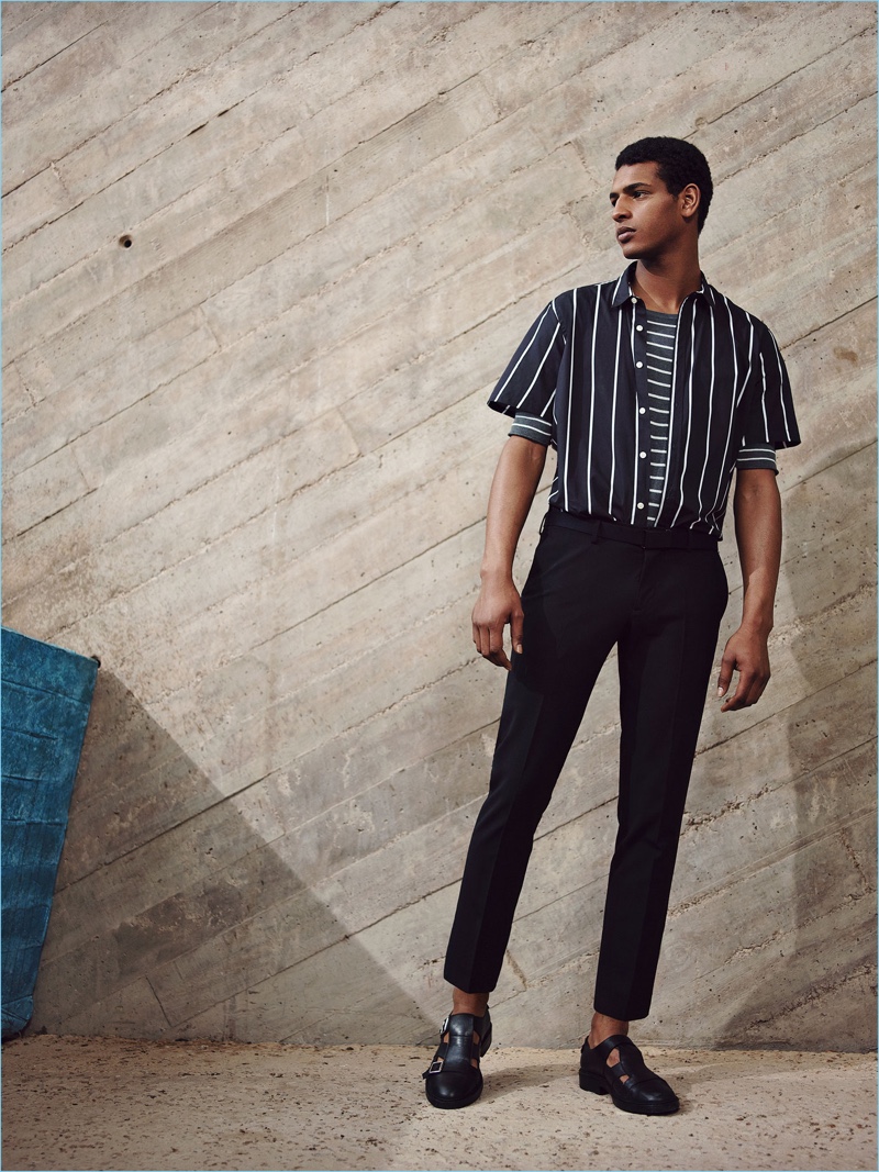 Standing tall, Tidiou M'Baye mixes vertical and horizontal stripe fashions from Zara Man.