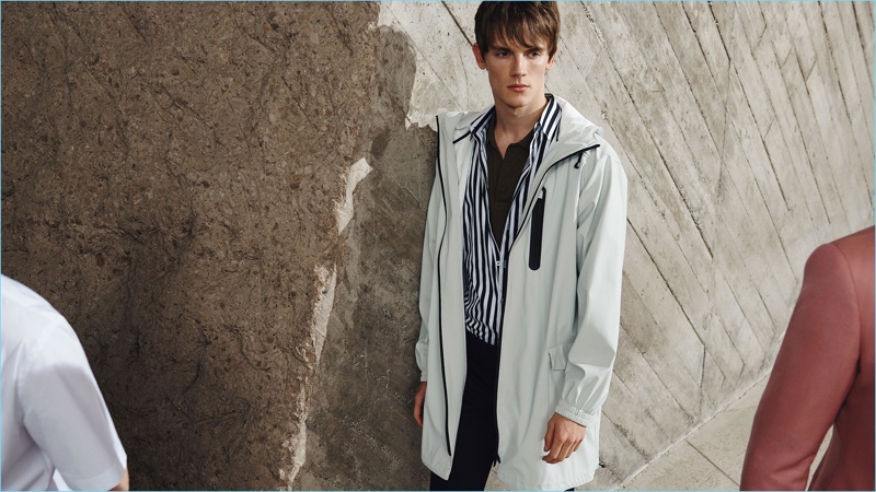 British model Callum Ward sports a parka and striped shirt from Zara Man.