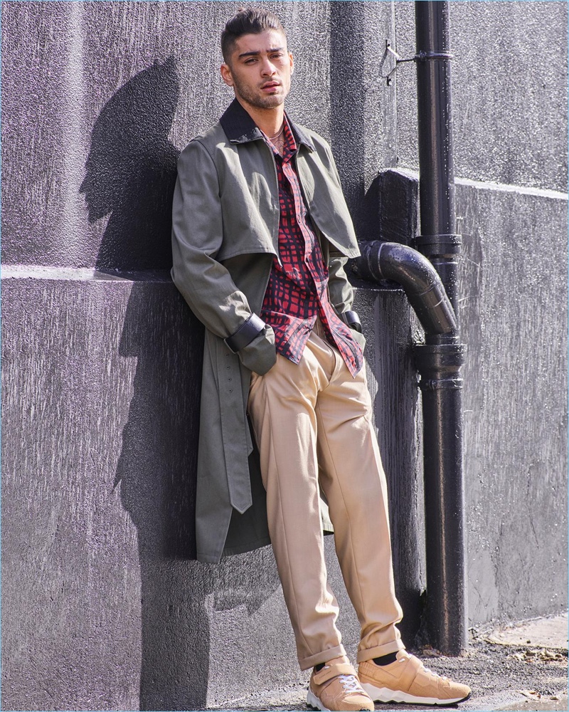 Going casual, Zayn Malik wears a plaid Coach shirt with a Valentino trench coat and Louis Vuitton trousers. Malik also rocks Pierre Hardy beige sneakers.