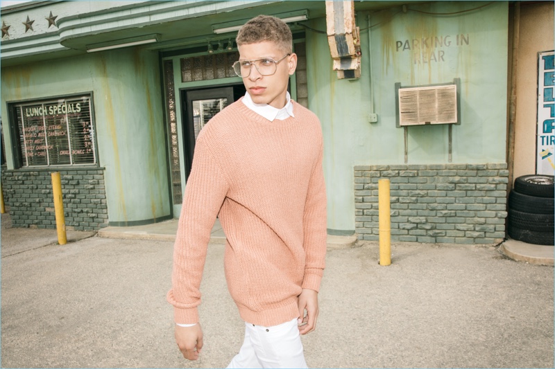 Wearing glasses, Chuck Achike sports an oversized ribbed sweater for boohooMAN's spring 2017 campaign.