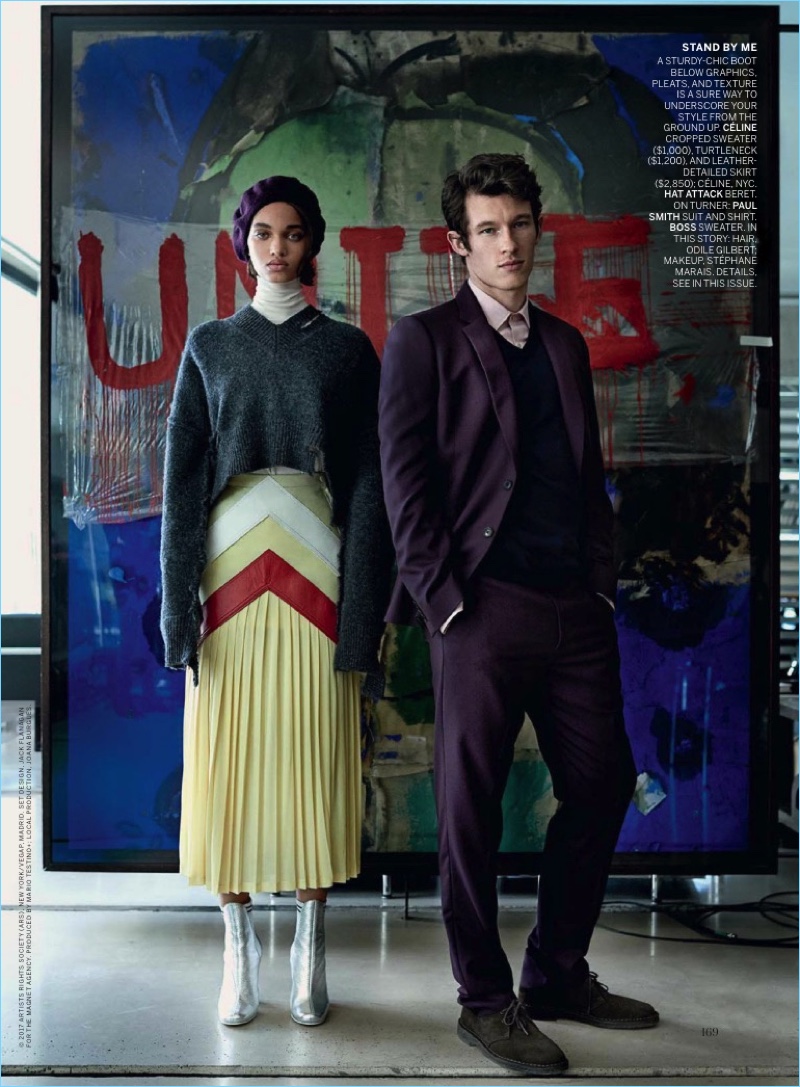 Standing tall with Ellen Rosa, Callum Turner sports a Paul Smith shirt and purple suit with a BOSS Hugo Boss sweater.