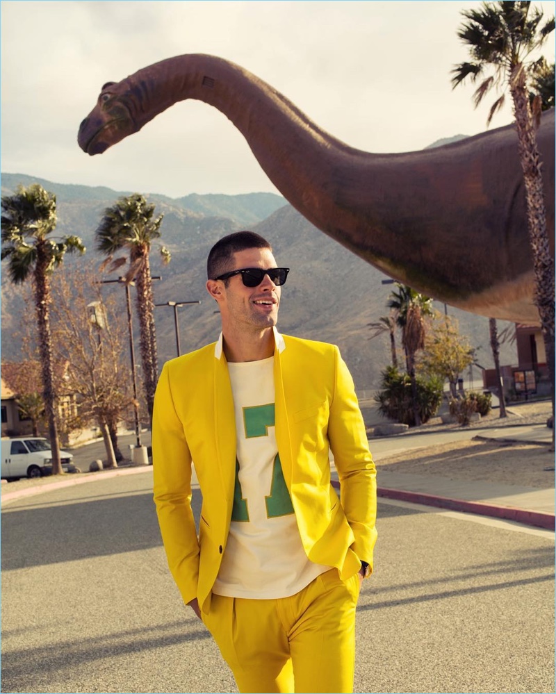 Chad White wears a yellow Paul Smith suit and graphic t-shirt with Ray-Ban sunglasses.