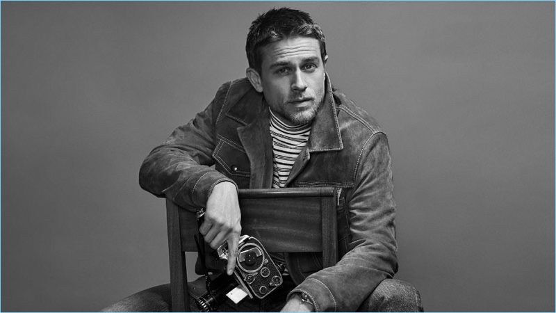 Charlie Hunnam wears a Prada slim-fit suede jacket $3120, Maison Margiela striped mock neck t-shirt $395, and slim-fit distressed denim jeans $545.