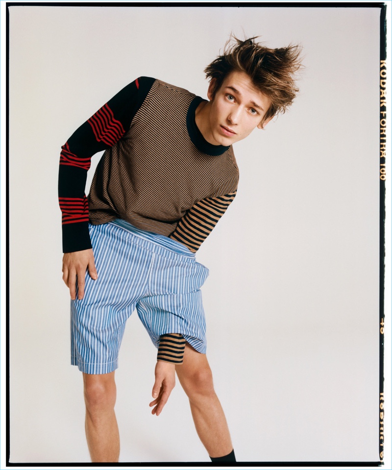 Jason Rider outfits Christopher Einla in a Golden Goose Deluxe brand striped t-shirt, McQ Alexander McQueen tee, and Comme des Garçons Shirt shorts.