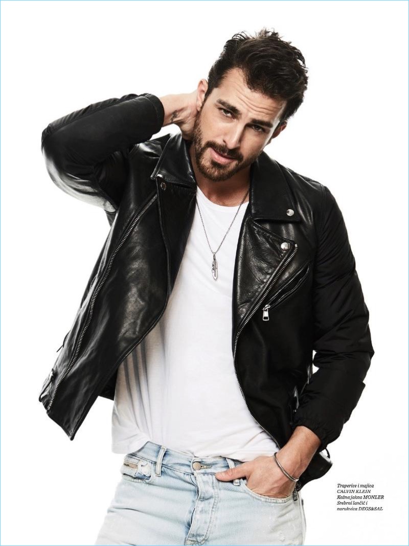 Sporting classic style, Clint Mauro wears a leather biker jacket with a simple tee and light wash jeans.