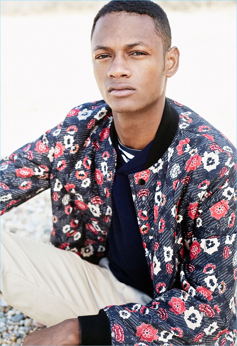 Lucas Cristino wears a Club Monaco printed floral bomber jacket $229 with a polo, striped tee $49, and chinos $98.50.