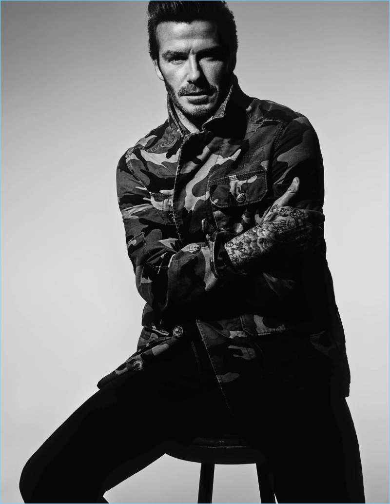 Embracing camouflage, David Beckham wears a Valentino jacket with Saint Laurent jeans.