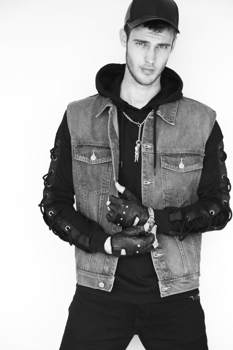 Max wears black denim jeans Wrangler, accessories XXL Hardwear, sweatshirt and denim vest BSK.