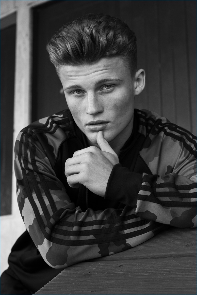 Zach wears tracksuit jacket Adidas Originals and tank AllSaints.