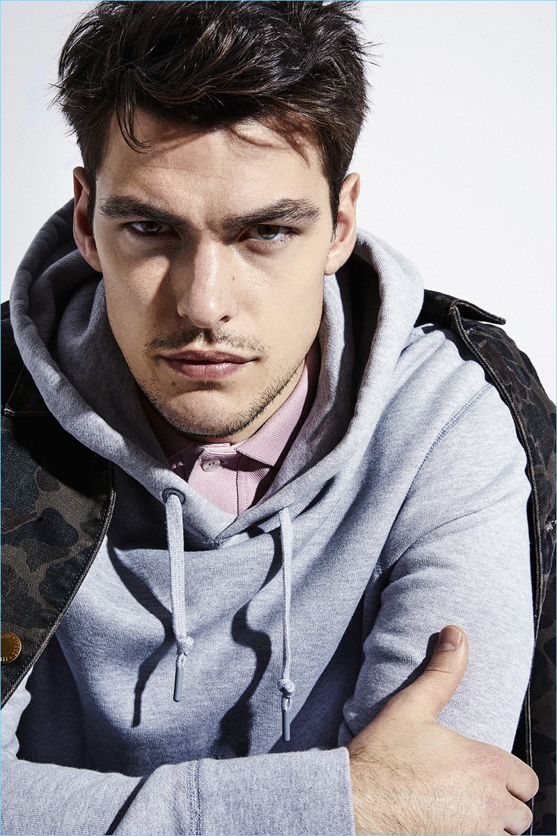 Model Filip Wolfe wears a Levi's jacket with a Converse hoodie and Nikolaj D'Étoiles polo.