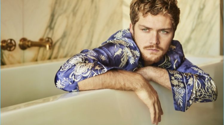 Finn Jones wears a patterned shirt by Roberto Cavalli for Interview magazine.