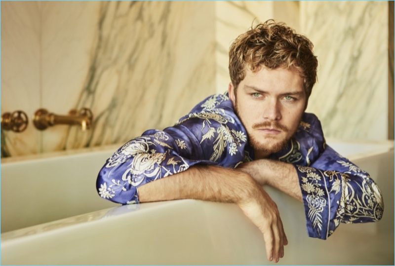 Finn Jones wears a patterned shirt by Roberto Cavalli for Interview magazine.