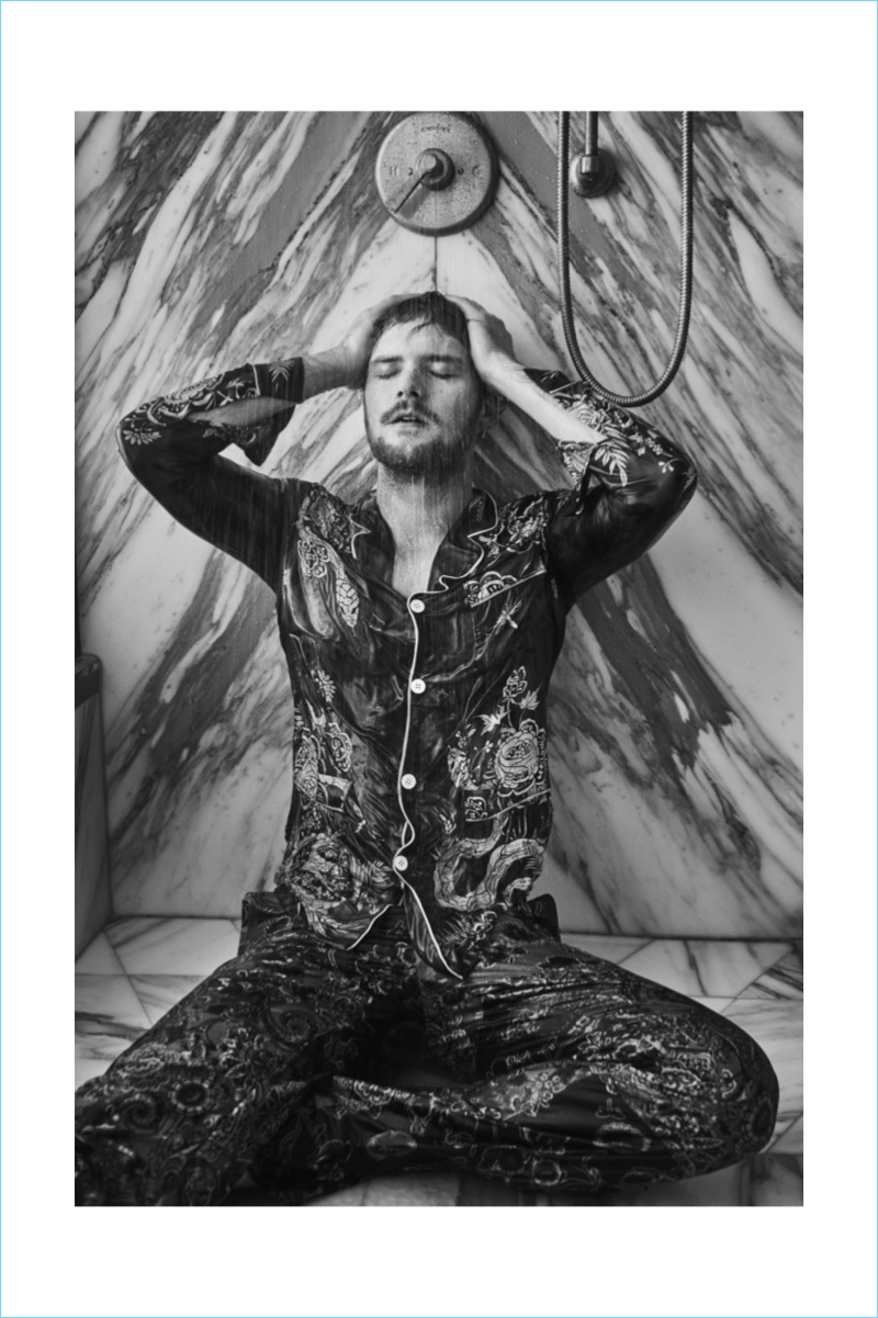 Captured in the shower, Finn Jones wears a pajama-inspired shirt and pants from Roberto Cavalli.