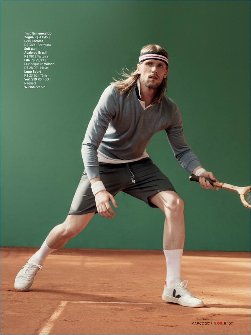 Playing tennis, Fellipe Wermuth wears an Ermenegildo Zegna sweater with a Lacoste polo, Suit shorts, and Vert V10 sneakers.