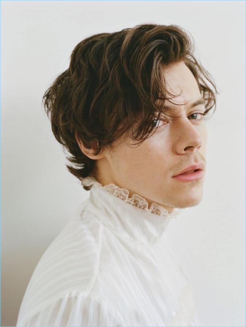 Front and center, Harry Styles wears a lace trimmed top for Rolling Stone.