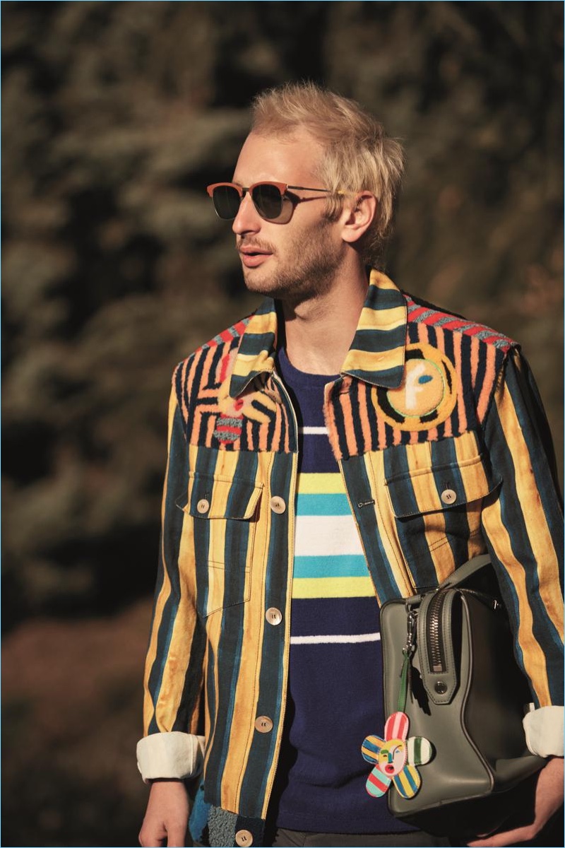 Making a colorful statement, Hopper Penn wears Fendi QBIC leather and yellow sunglasses $625 with a multicolored cotton jacket $4,900.