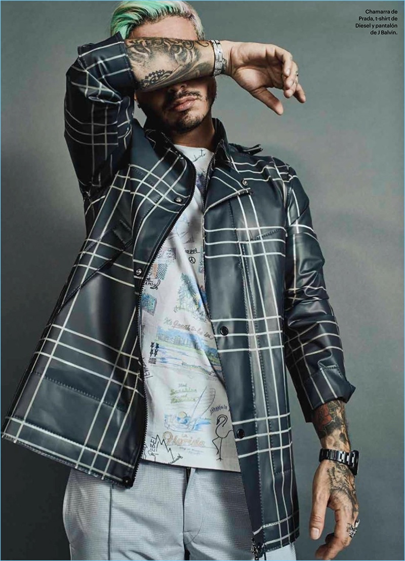 Posing for a new photo shoot, J. Balvin sports a Prada jacket, Diesel t-shirt, and his own trousers.