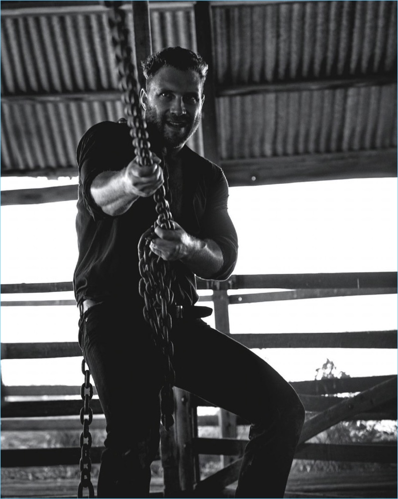 Putting in a hard day's work, Jai Courtney wears a Commas shirt with a belt and denim jeans by RM Williams.