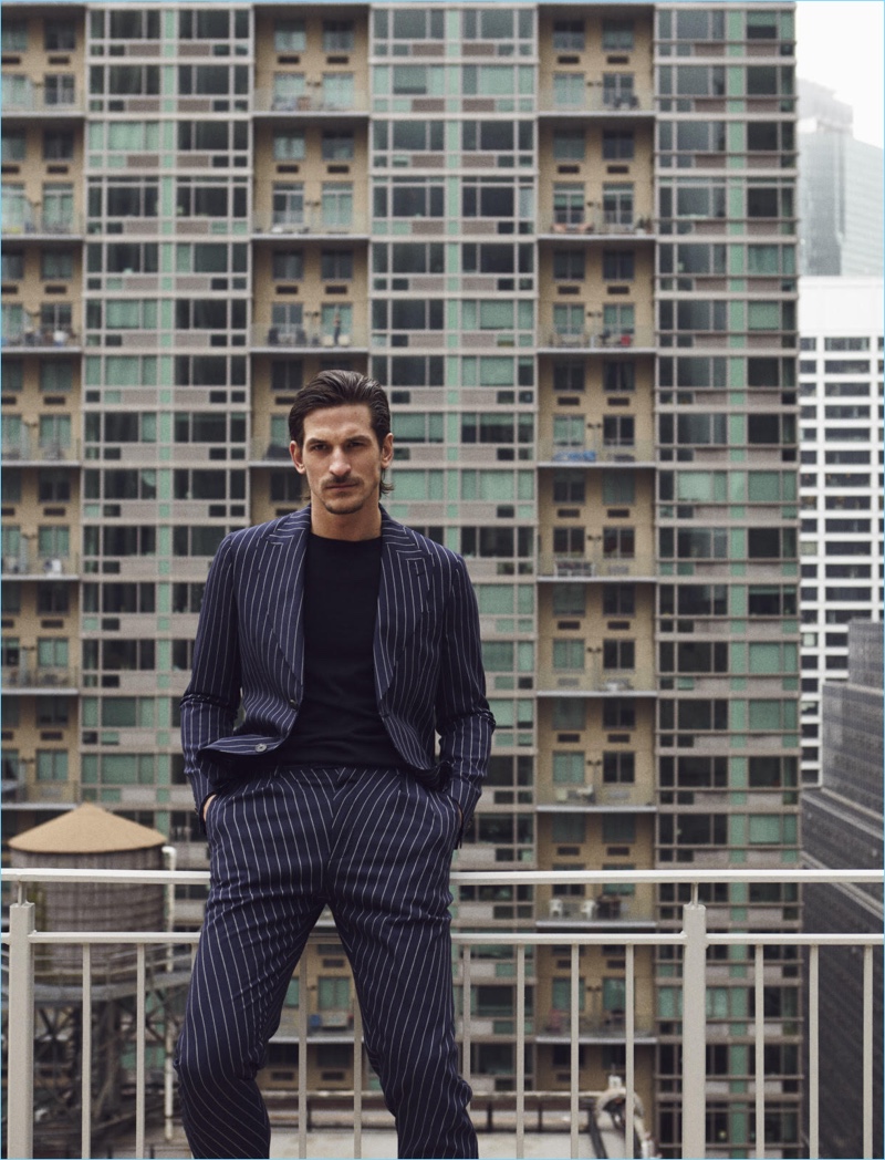 Jarrod Scott dons a pinstripe Etro suit with an Ermenegildo Zegna sweater.