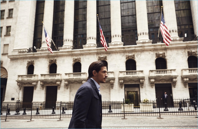 On the move, Jarrod Scott dons a Salvatore Ferragamo jacket with Hackett London shirt.