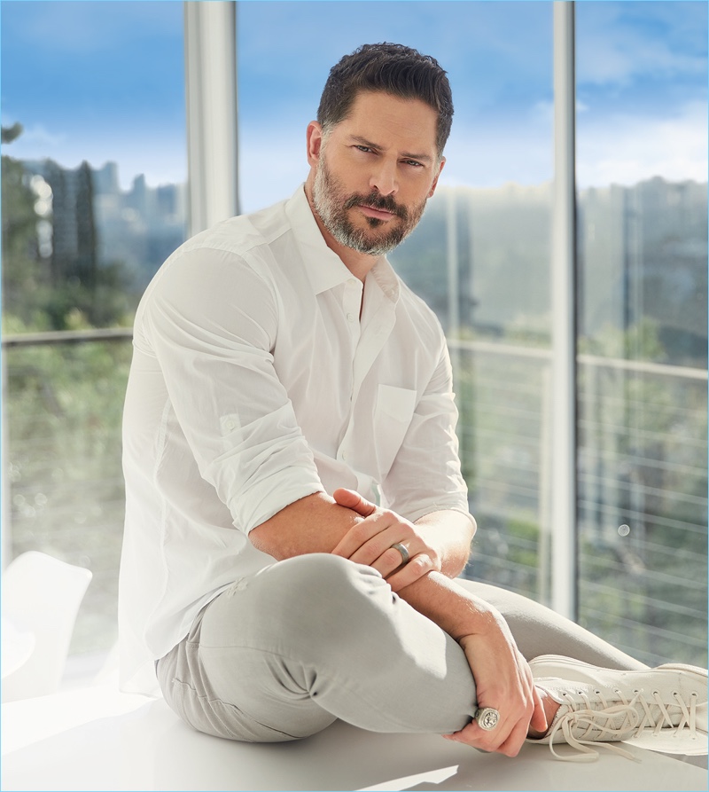 A summer vision, Joe Manganiello wears a John Varvatos white shirt with Bottega Veneta jeans, and Converse high-top sneakers.