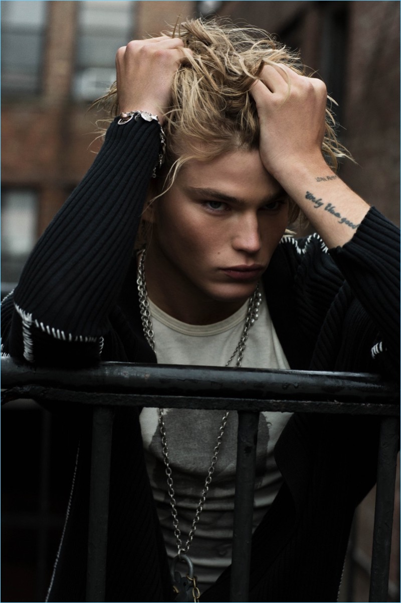 Front and center, Jordan Barrett wears a long ribbed cardigan by Ann Demeulemeester.