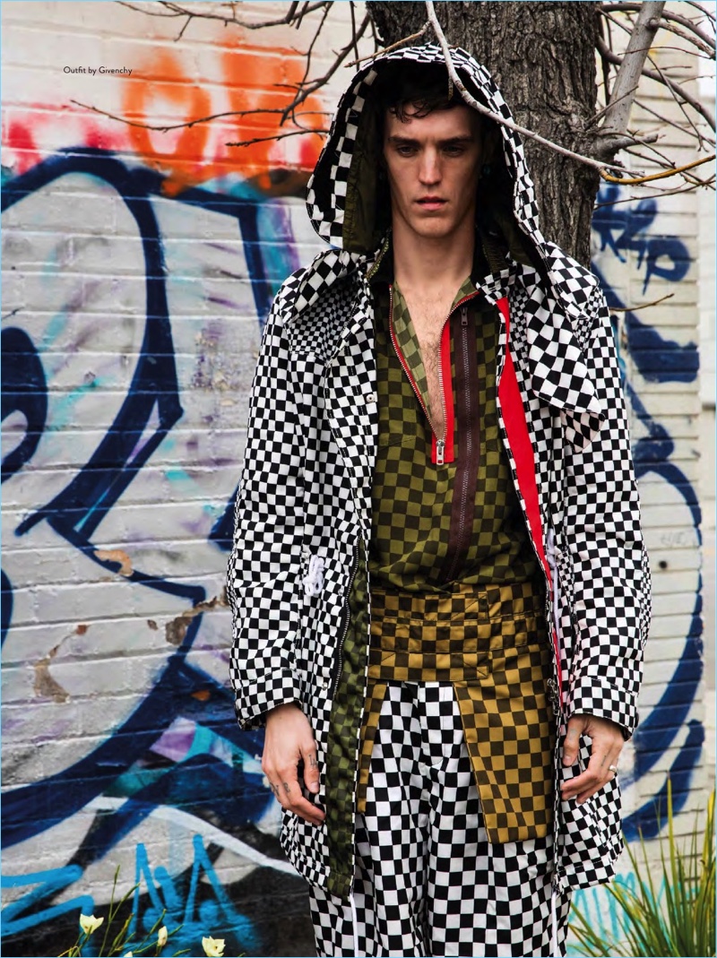 Clad in a checkerboard print, Josh Beech sports a spring ensemble from Givenchy.