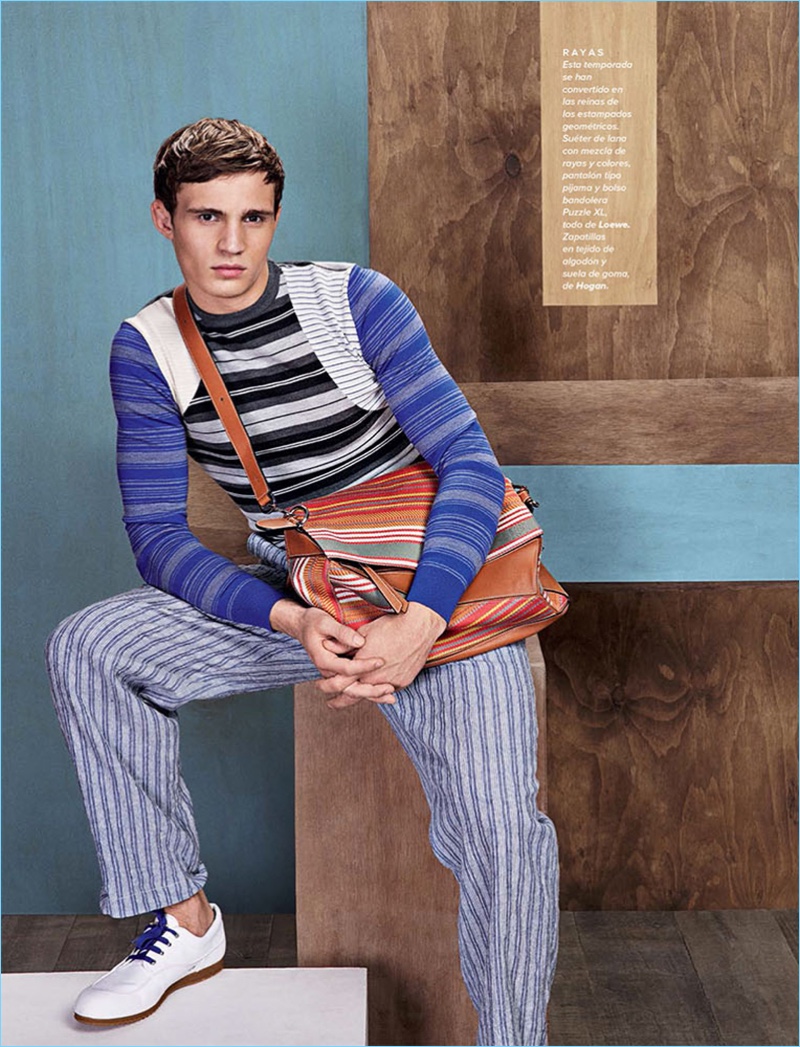 Embracing stripes, Julian Schneyder wears a sweater and pants by Loewe with Hogan shoes.