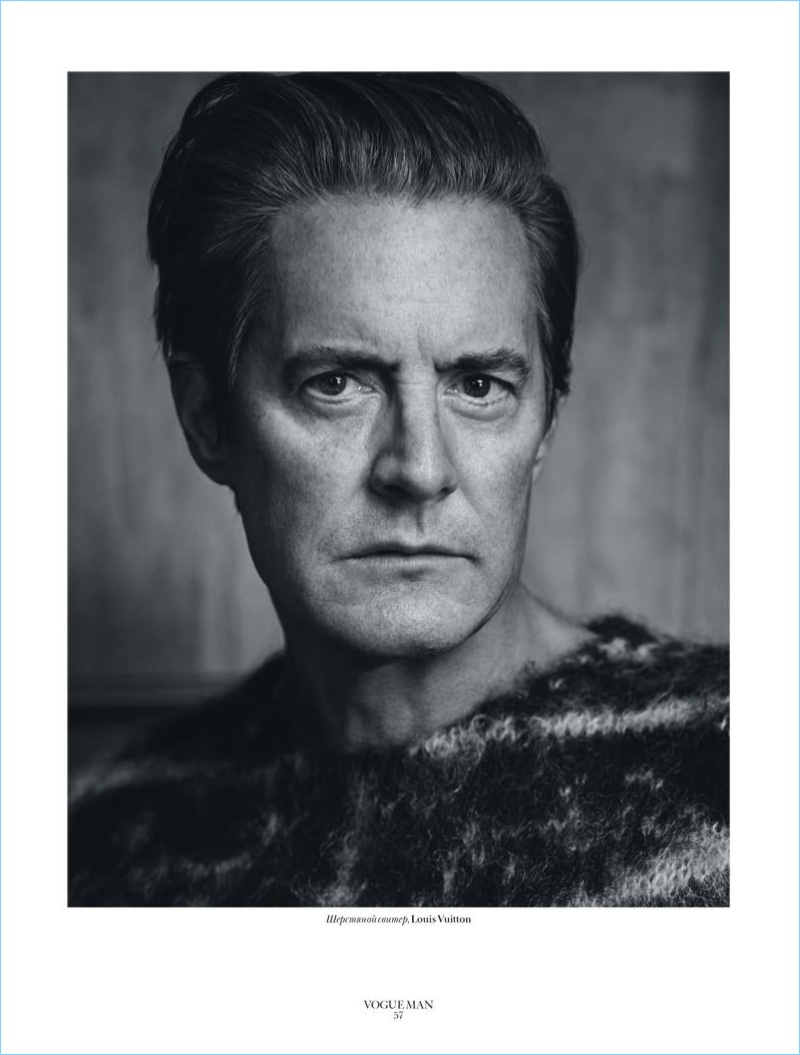 Appearing in a black and white image, Kyle MacLachlan sports a Louis Vuitton sweater.