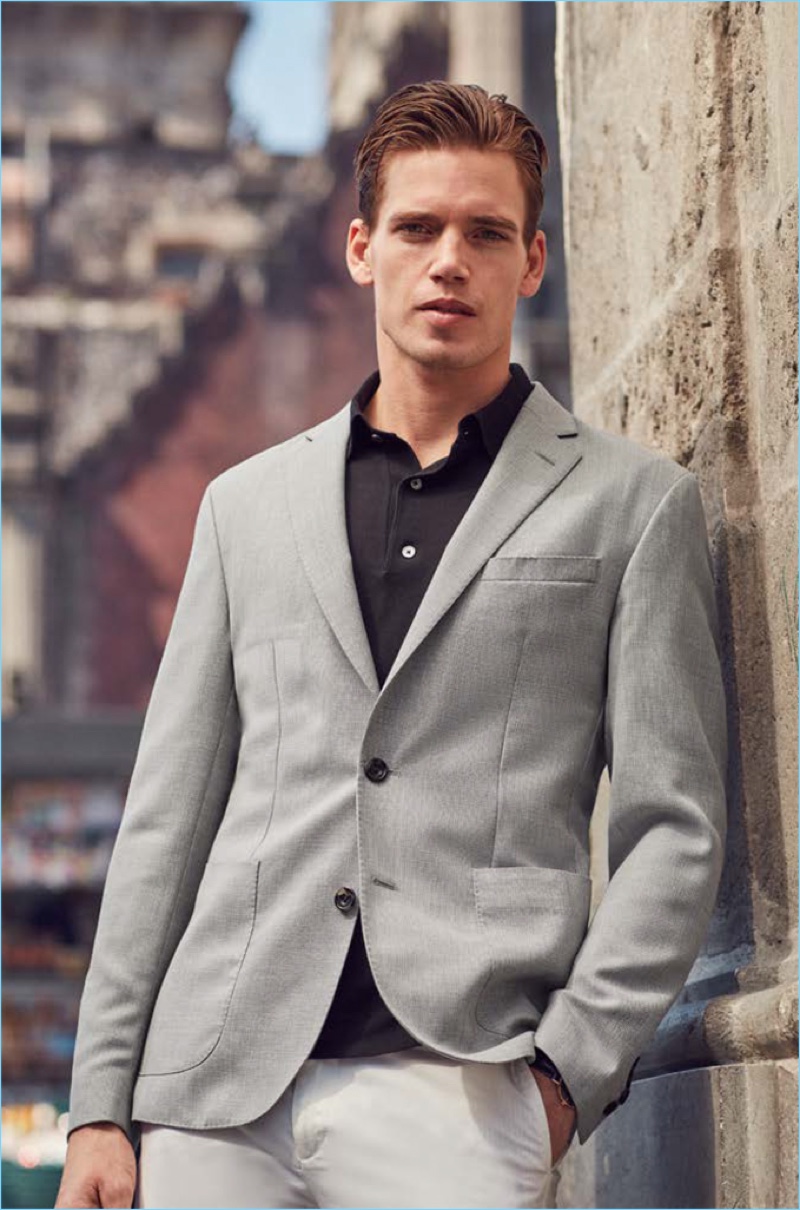 A smart vision, Mark Cox dons a grey sport coat, blazer, and pants from Black Brown 1826.