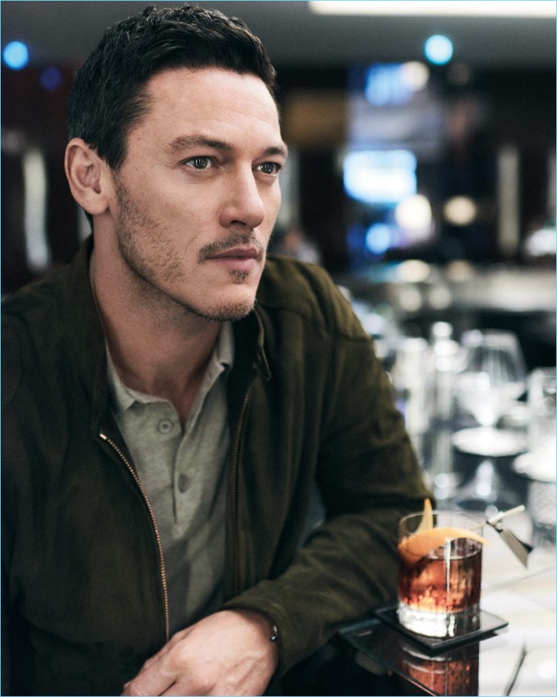 Enjoying a drink, Luke Evans dons a Private White V.C. suede bomber jacket and Thom Sweeney polo.