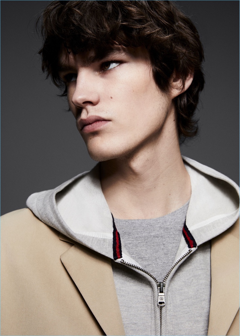 Creating a layered moment, Elias de Poot wears a Mango Man cotton trench coat $139.99, hoodie $49.99, and flecked cotton-blend t-shirt $19.99.