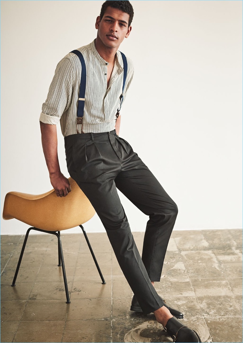 Making a case for suspenders, Tidiou M'Baye wears Mango Man adjustable elastic braces $49.99. He also sports a Mango Man striped grandad collar shirt $49.99, pleated trousers $59.99, and leather monk strap shoes $119.99.
