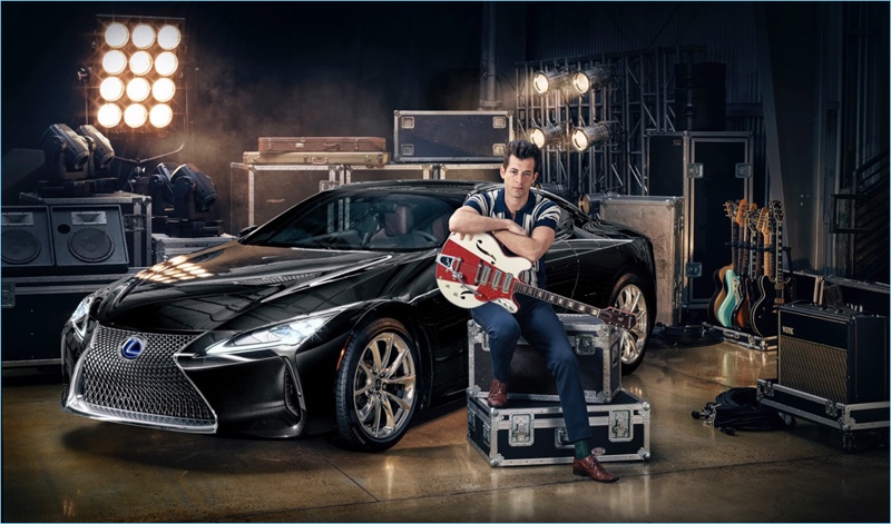 Posing with Lexus' LC coupe, Mark Ronson sports a retro-style polo shirt with slim-fit trousers.