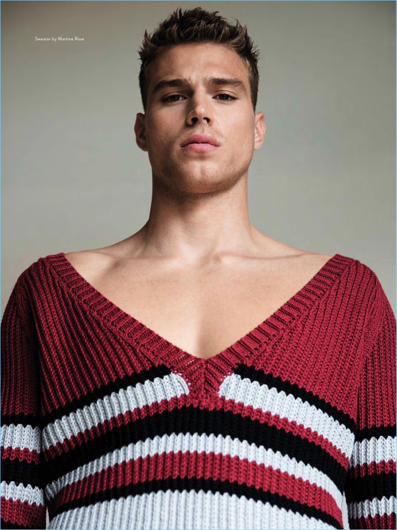 Model Matthew Noszka wears a colorful sweater by Martine Rose.