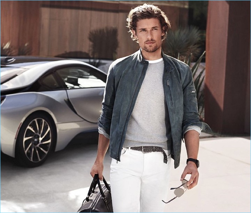 Ready to hit the road, Wouter Peelen sports a grey suede jacket and white jeans from Michael Kors.