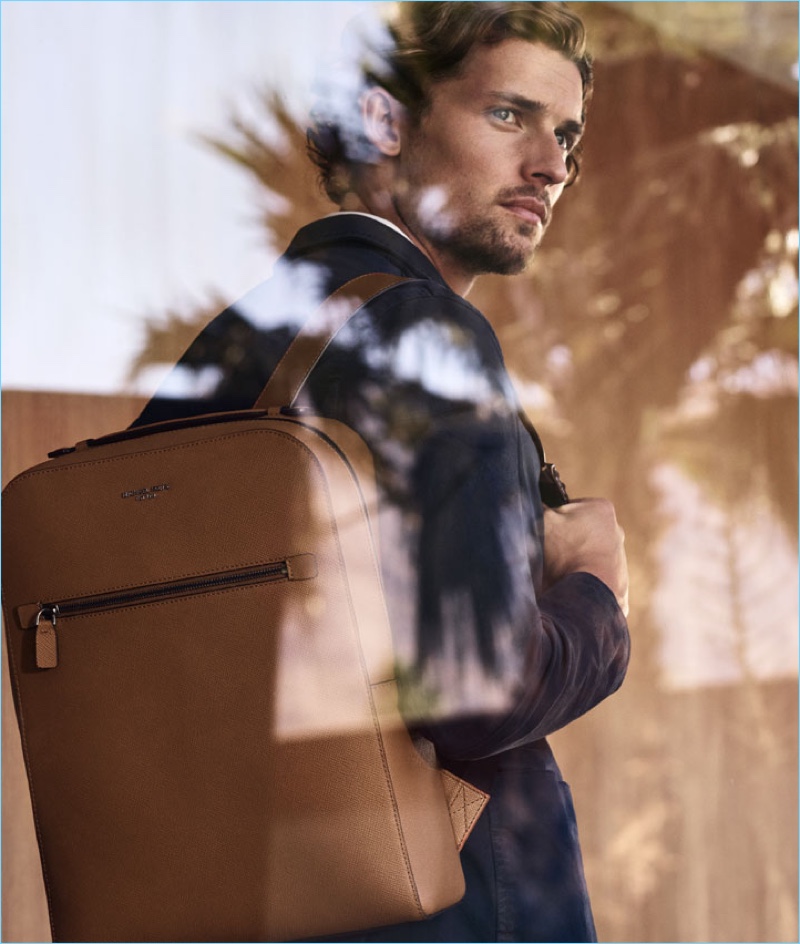 Wouter Peelen sports a brown leather backpack from Michael Kors.
