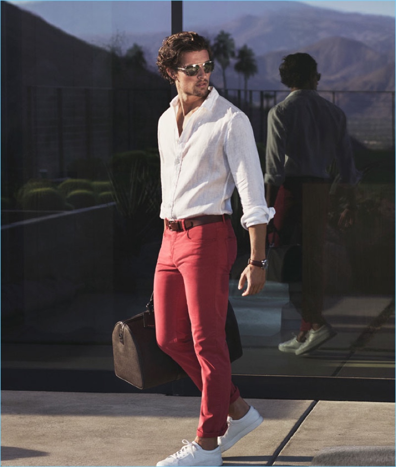 Dutch model Wouter Peelen dons a linen shirt and red pants with white sneakers by Michael Kors.